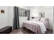 Cozy bedroom featuring a comfortable bed, soft carpet, and plenty of natural light from a window at 1885 S Quebec Way # G 106, Denver, CO 80231