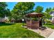 Lush, green community area with a charming wooden gazebo and walkway access throughout at 1885 S Quebec Way # G 106, Denver, CO 80231