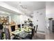 Dining room area featuring a table set for meal and view of the modern kitchen at 1885 S Quebec Way # G 106, Denver, CO 80231