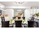 Dining area with a glass table, comfortable seating, and open view to the kitchen at 1885 S Quebec Way # G 106, Denver, CO 80231