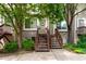 Charming townhome with inviting staircases leading to front doors and mature trees at 1885 S Quebec Way # G 106, Denver, CO 80231