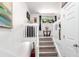 Bright hallway with stairs, table with orchid and small plants at 1885 S Quebec Way # G 106, Denver, CO 80231