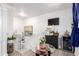 Bright hallway with stairs, table with orchid and small plants, and a wine cooler at 1885 S Quebec Way # G 106, Denver, CO 80231