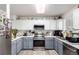 Bright kitchen featuring white and gray cabinets, stainless steel appliances, and modern finishes at 1885 S Quebec Way # G 106, Denver, CO 80231