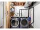 Laundry room features a washer and dryer, with exposed pipes and ductwork at 1885 S Quebec Way # G 106, Denver, CO 80231