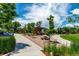 Community picnic area with tables, benches, and lush landscaping at 1885 S Quebec Way # G 106, Denver, CO 80231