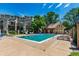 Community pool surrounded by lounge chairs, with building and trees in the background at 1885 S Quebec Way # G 106, Denver, CO 80231