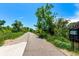 Community trail lined with lush greenery at 1885 S Quebec Way # G 106, Denver, CO 80231
