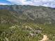 Stunning aerial view of a home surrounded by a vast forest landscape at 173 Silver Cloud Ln, Boulder, CO 80302