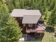 Aerial shot featuring a rooftop, deck, and the surrounding lush trees at 173 Silver Cloud Ln, Boulder, CO 80302