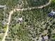 Aerial view of property, surrounded by dense woods; lot line approximate is visible at 173 Silver Cloud Ln, Boulder, CO 80302