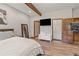 Modern bedroom featuring hardwood floors, stylish decor, and en suite bathroom at 173 Silver Cloud Ln, Boulder, CO 80302