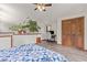 Bedroom with desk area, ceiling fan, wood floors, and double door closet at 173 Silver Cloud Ln, Boulder, CO 80302