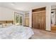 Bright bedroom features wood floors, sliding glass door, and ample closet space at 173 Silver Cloud Ln, Boulder, CO 80302