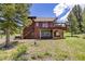 Rear exterior view of a two-story home featuring a large deck and stairs leading to the backyard at 173 Silver Cloud Ln, Boulder, CO 80302