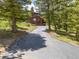 View of a two-story home with a long driveway and surrounding trees, showcasing its serene setting at 173 Silver Cloud Ln, Boulder, CO 80302