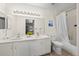 The bright bathroom features double sinks and a tub, enhanced by natural light at 8435 Pebble Creek Way # 104, Highlands Ranch, CO 80126