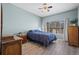 This bedroom offers ample natural light and is complemented by classic wooden furniture at 8435 Pebble Creek Way # 104, Highlands Ranch, CO 80126