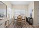 Bright dining area with large windows and contemporary furnishings at 8435 Pebble Creek Way # 104, Highlands Ranch, CO 80126
