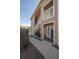 Exterior entrance to a condo with a stairway and a well maintained rock and mulch landscape at 8435 Pebble Creek Way # 104, Highlands Ranch, CO 80126