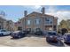 Inviting exterior of a two-story condo with ample parking and well-maintained landscaping at 8435 Pebble Creek Way # 104, Highlands Ranch, CO 80126