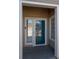 Entrance to a condo with a blue door, adjacent window, and visible unit number at 8435 Pebble Creek Way # 104, Highlands Ranch, CO 80126