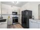 Well-lit kitchen featuring stainless steel appliances, light cabinetry, and wood-look flooring at 8435 Pebble Creek Way # 104, Highlands Ranch, CO 80126