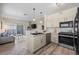 Modern kitchen with granite countertops and stainless steel appliances that opens to the living room at 8435 Pebble Creek Way # 104, Highlands Ranch, CO 80126