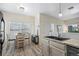Bright kitchen with a breakfast bar, table seating, and granite countertops at 8435 Pebble Creek Way # 104, Highlands Ranch, CO 80126
