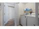 Bright laundry room with modern washer and dryer, complemented by convenient shelving at 8435 Pebble Creek Way # 104, Highlands Ranch, CO 80126
