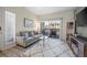 Bright living room with a sliding glass door and a cozy area rug at 8435 Pebble Creek Way # 104, Highlands Ranch, CO 80126