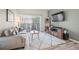 Cozy living room with a neutral color palette, TV, and sliding glass door at 8435 Pebble Creek Way # 104, Highlands Ranch, CO 80126
