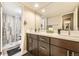 A modern bathroom with a double sink vanity, stylish fixtures, and a glass enclosed shower, for a sleek design at 4250 S Olive St # 102, Denver, CO 80237