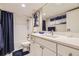 Bathroom featuring a shower with blue curtain, white vanity, and modern fixtures at 4250 S Olive St # 102, Denver, CO 80237