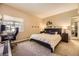 A cozy bedroom featuring a queen-sized bed, bedside tables with lamps and an office desk at 4250 S Olive St # 102, Denver, CO 80237