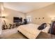 Bedroom with a large bed and a TV and desk area, providing a comfortable space to relax and work at 4250 S Olive St # 102, Denver, CO 80237