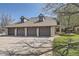 Attached residential garages with brown doors and visible unit numbers with green lawn at 4250 S Olive St # 102, Denver, CO 80237
