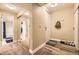 Bright hallway with wood-style floors, closet with mirror, and a door to the bathroom at 4250 S Olive St # 102, Denver, CO 80237