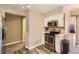 Modern kitchen featuring stainless steel appliances, sleek cabinets, and stylish wood-look floors, offering a contemporary design at 4250 S Olive St # 102, Denver, CO 80237