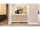 A charming kitchenette space with light colored cabinets and a stylish separation of the kitchen and living room spaces at 4250 S Olive St # 102, Denver, CO 80237