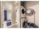 A convenient laundry area with stacked washer and dryer, showcasing functional design at 4250 S Olive St # 102, Denver, CO 80237
