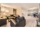Spacious living room featuring a leather sofa, TV, and fireplace with dining and work area beyond at 4250 S Olive St # 102, Denver, CO 80237