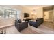 Cozy living room with a bay window, comfortable seating, and modern TV setup at 4250 S Olive St # 102, Denver, CO 80237