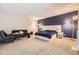 A large main bedroom featuring carpet floors, a navy accent wall, and a stylish white bed frame and headboard design at 4250 S Olive St # 102, Denver, CO 80237