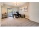 Well-lit home office with a sliding door, neutral walls, carpet floors and modern decorations to promote an elegant workspace at 4250 S Olive St # 102, Denver, CO 80237