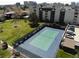 Community tennis court with on-site parking, surrounded by lush landscaping at 4250 S Olive St # 102, Denver, CO 80237