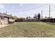 Expansive backyard with lush lawn, patio with furniture and privacy fence at 8651 Franklin St, Denver, CO 80229