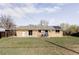 Large backyard with well-maintained lawn, brick exterior, solar panel and patio set at 8651 Franklin St, Denver, CO 80229