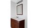 Bathroom vanity with white countertop, dark wood cabinets, modern faucet, and illuminated mirror at 8651 Franklin St, Denver, CO 80229