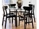 Close-up on a dining room table with four black chairs and centerpiece flower bouquet at 8651 Franklin St, Denver, CO 80229
